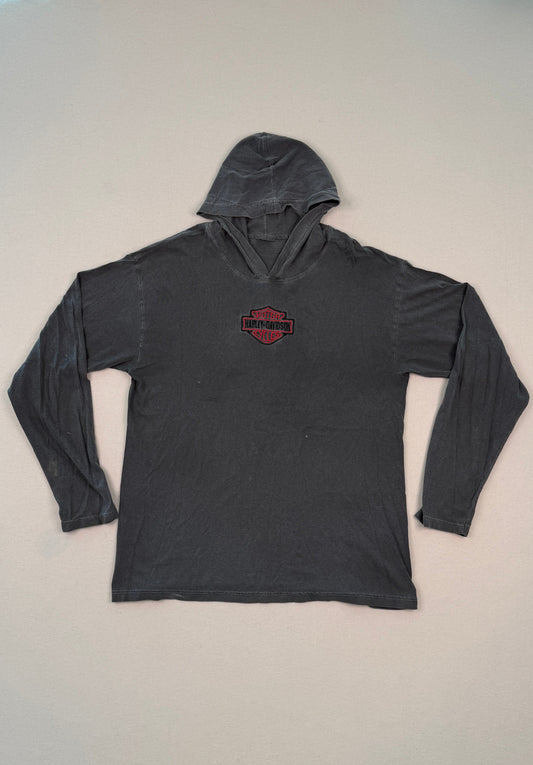 Dark gray hoodie with a red logo on a light gray surface