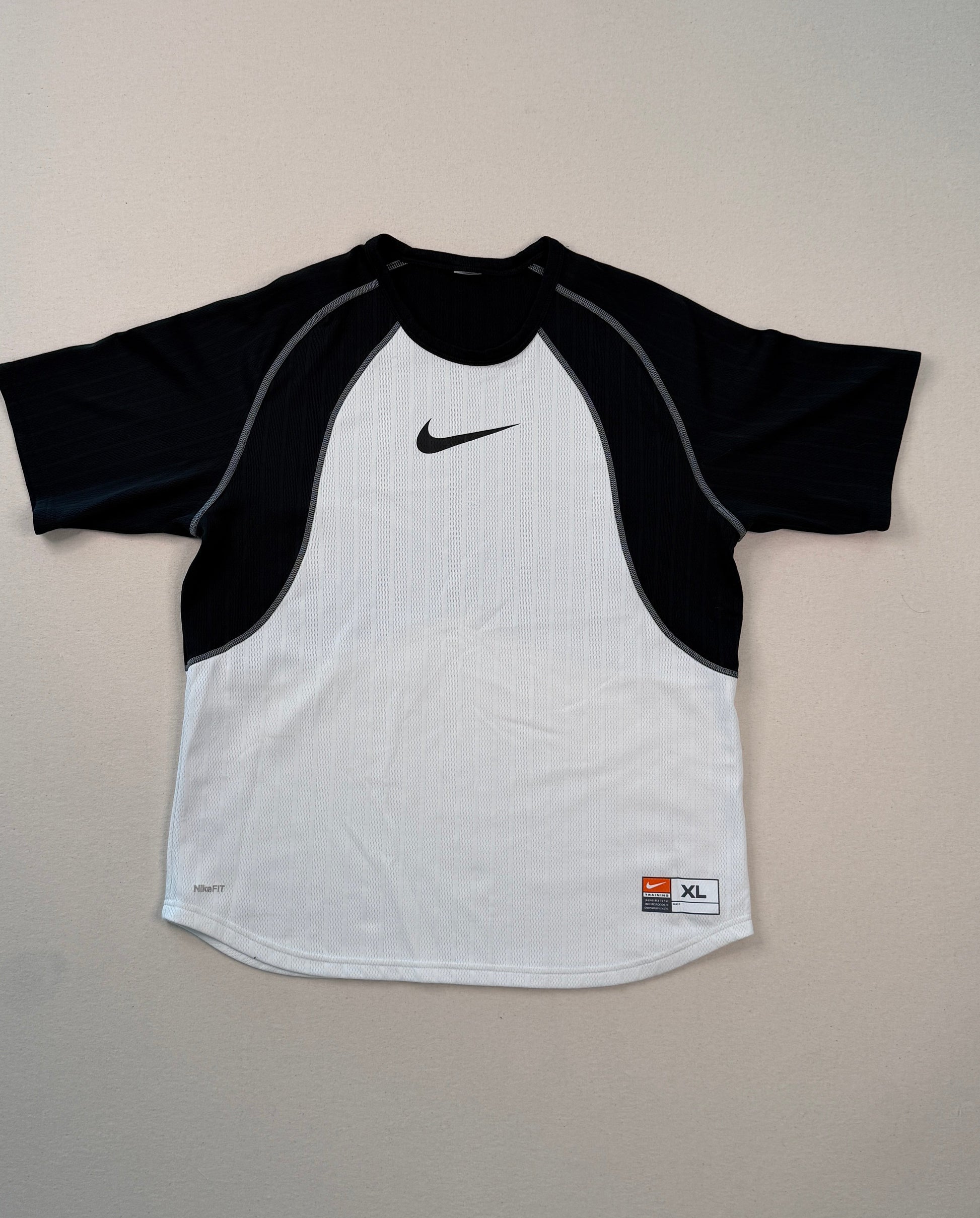 Black and white shirt with Nike logo on a light gray surface