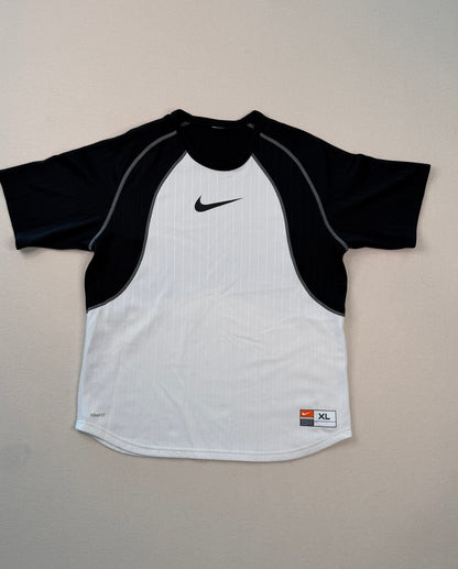 Black and white shirt with Nike logo on a light gray surface