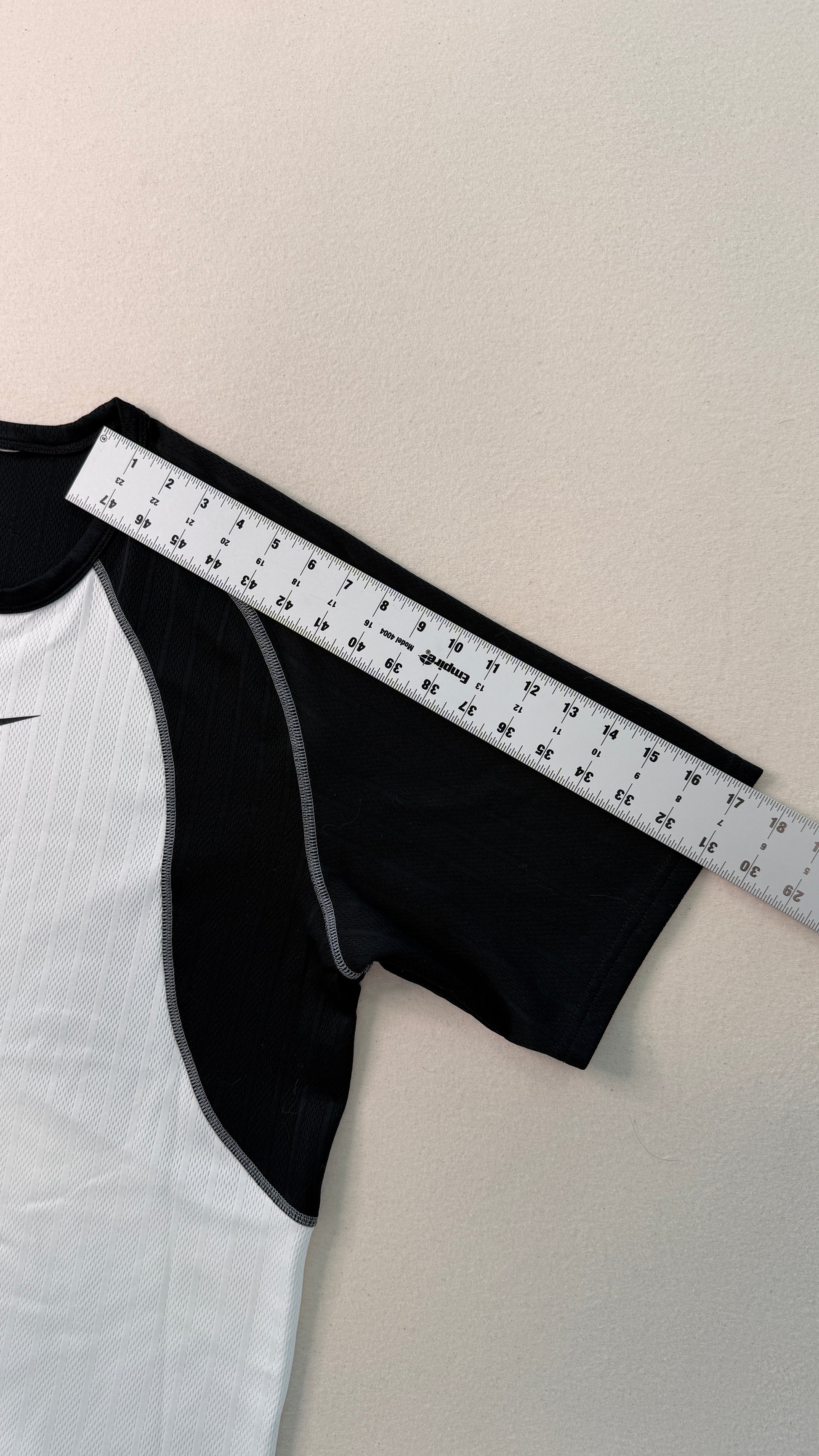 Black garment with a measuring tape on a white background
