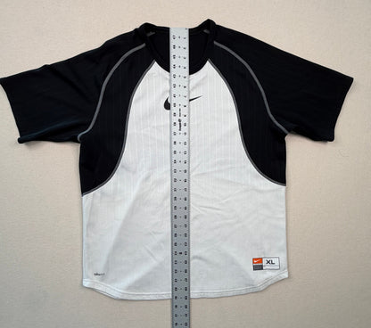 Black and white shirt with a ruler for size reference on a light gray background