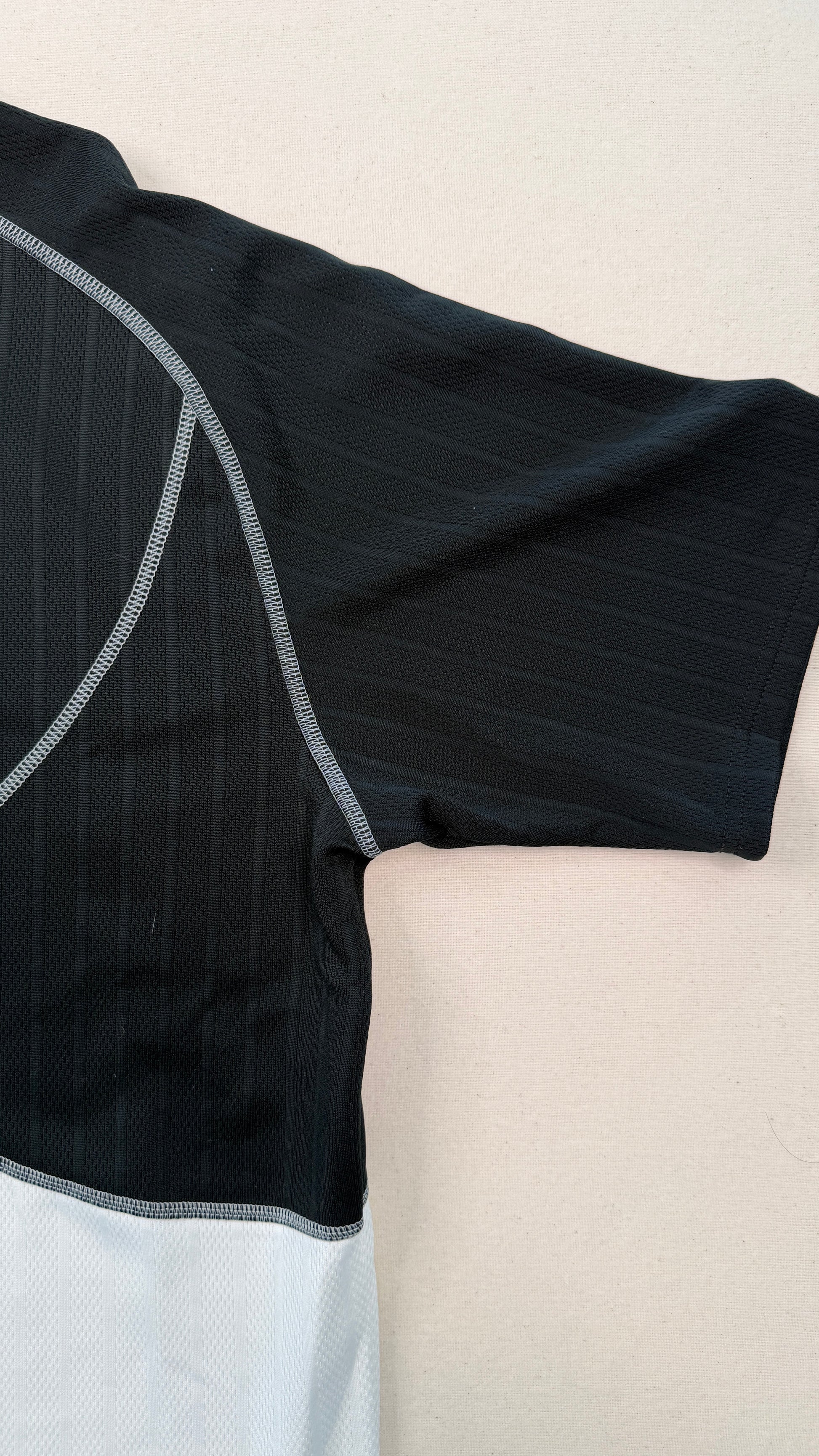 Black and gray athletic outfit on a beige surface