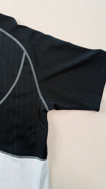 Black and gray athletic outfit on a beige surface