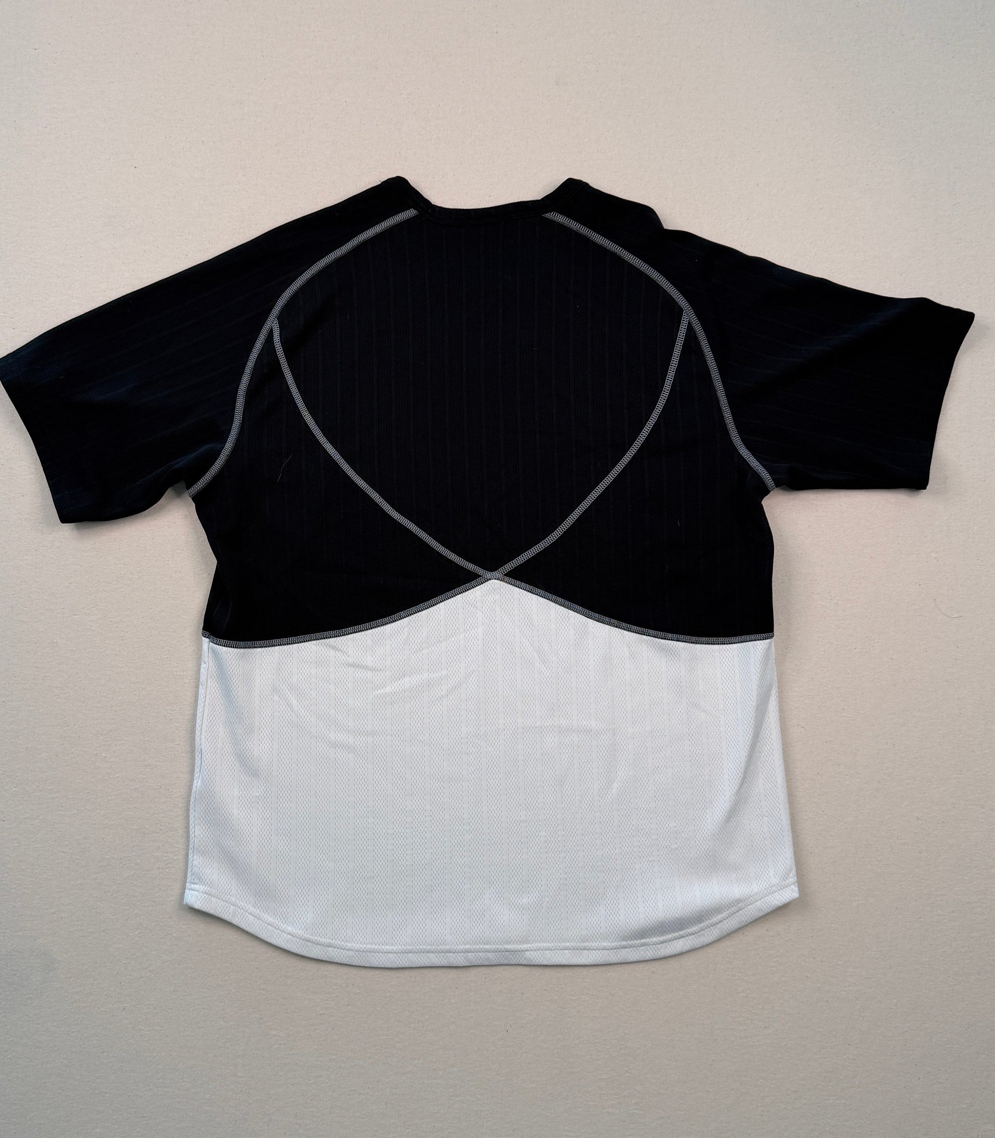 Black and white crop top on a light gray surface with a ruler at the bottom.