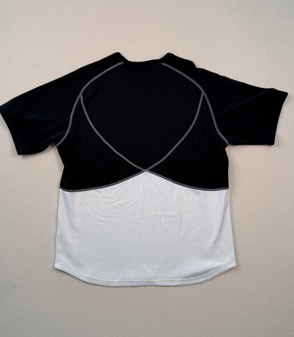 Black and white crop top on a light gray surface with a ruler at the bottom.