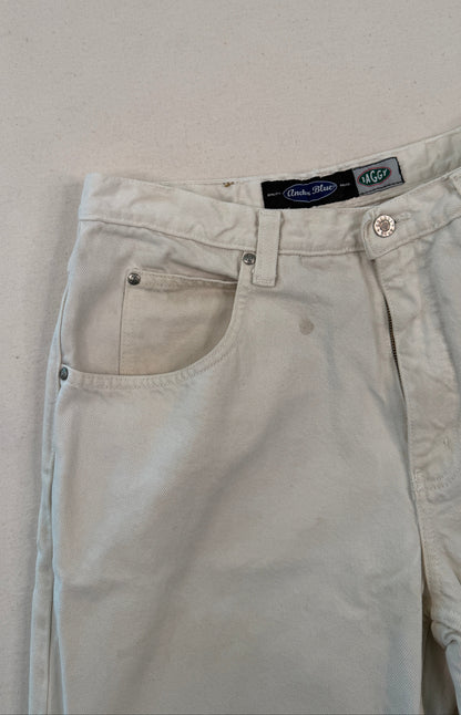 Beige pants with a brand label on a light gray background