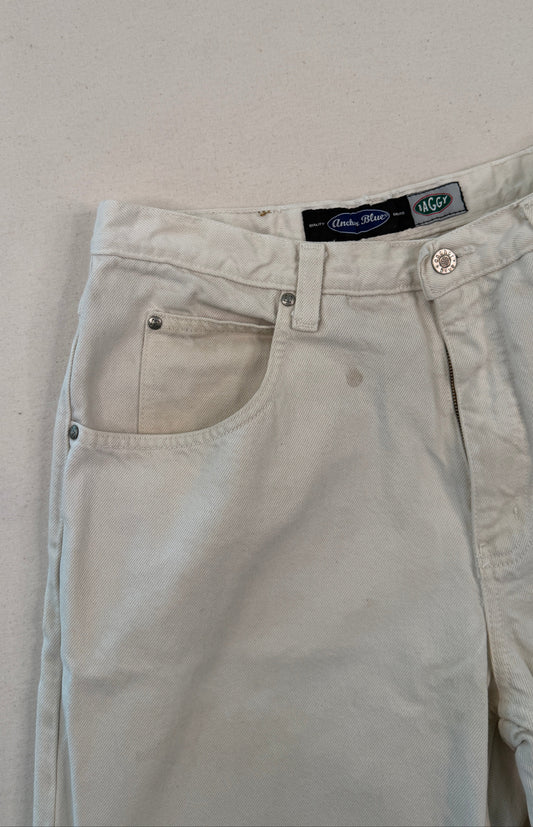 Beige pants with a brand label on a light gray background