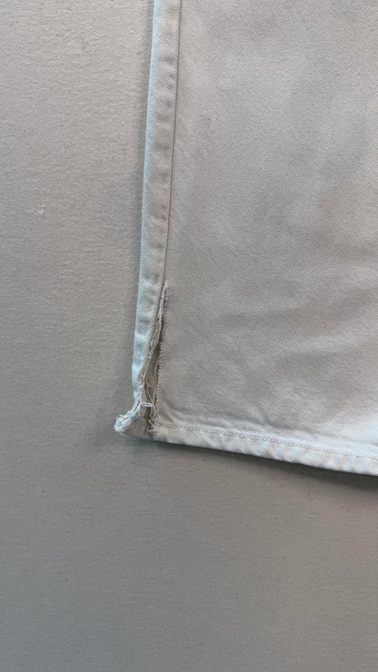 Close-up of a beige fabric corner on a plain background