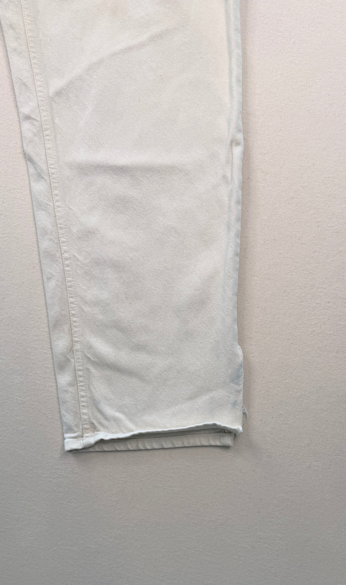Close-up of light-colored pants on a white background