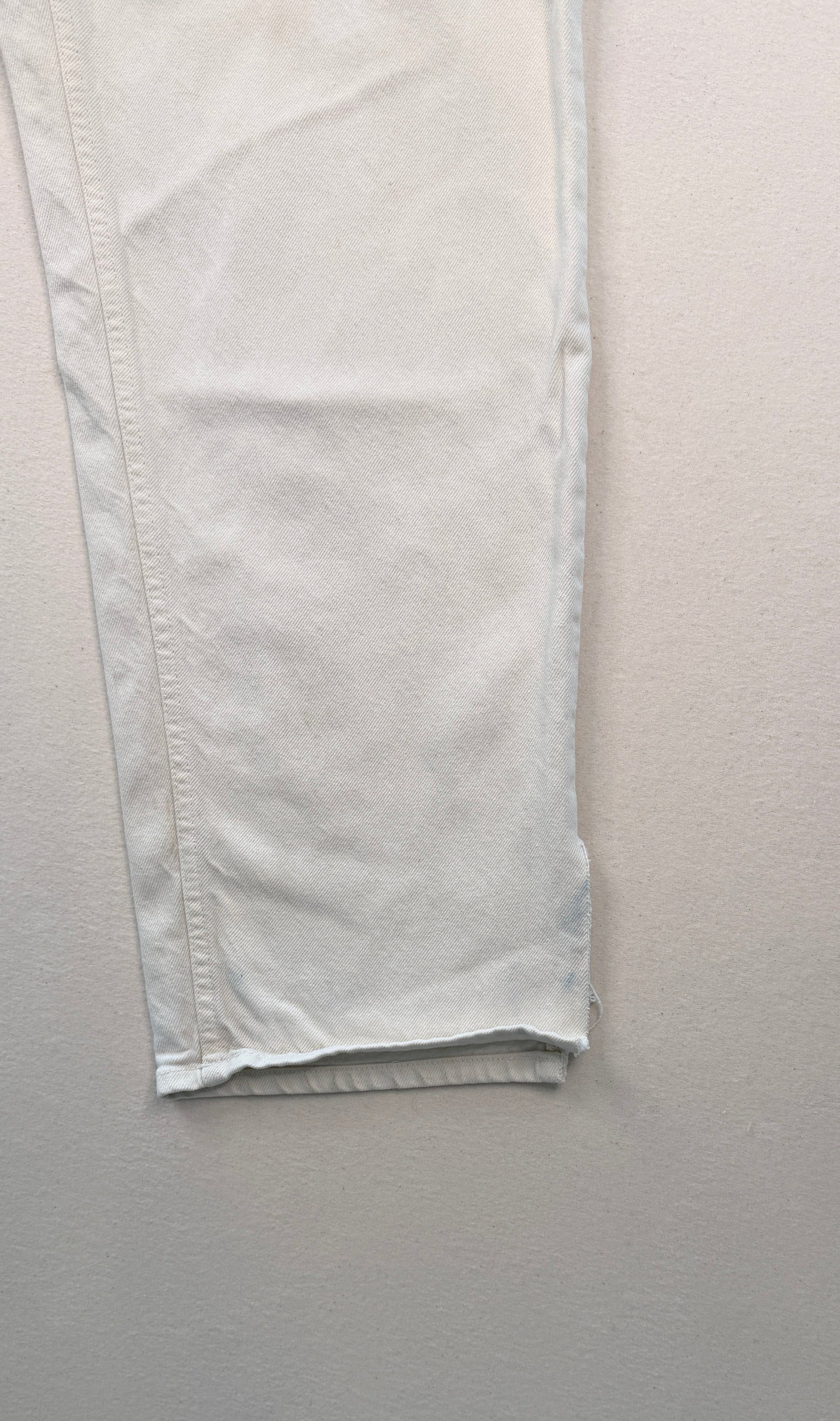 Close-up of light-colored pants on a white background