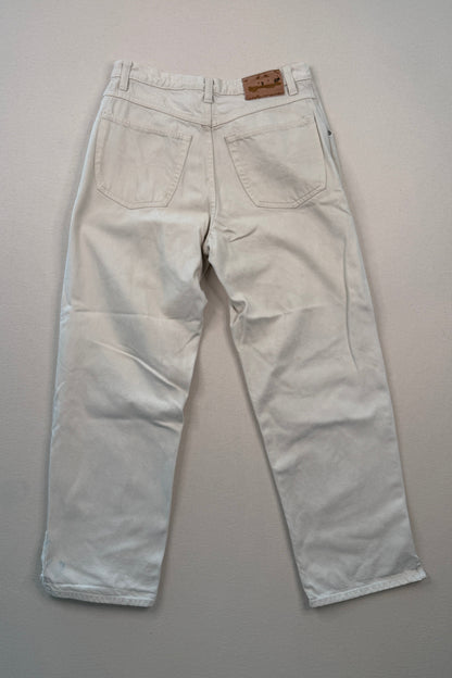 Light-colored pants on a gray surface with a ruler at the bottom.