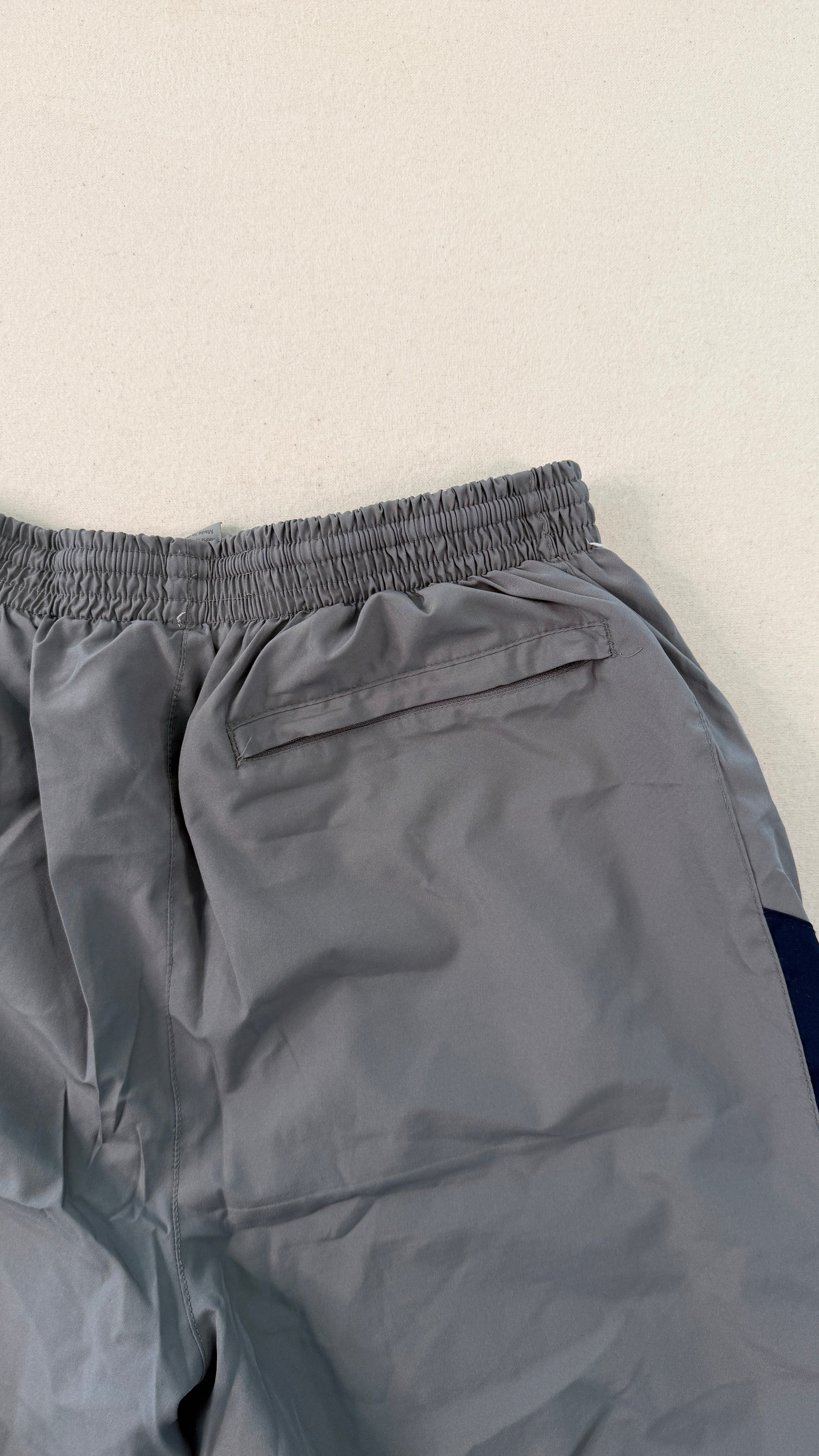 Gray pants with a pocket on a light beige background