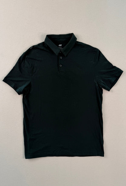 Black polo shirt on a light beige background