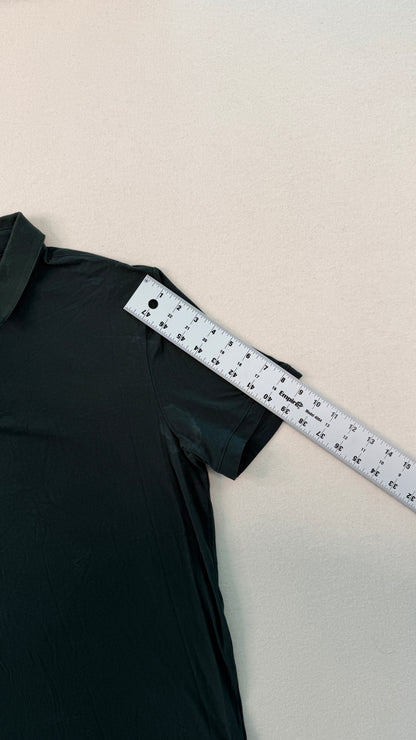 Black dress with a measuring tape on a beige background