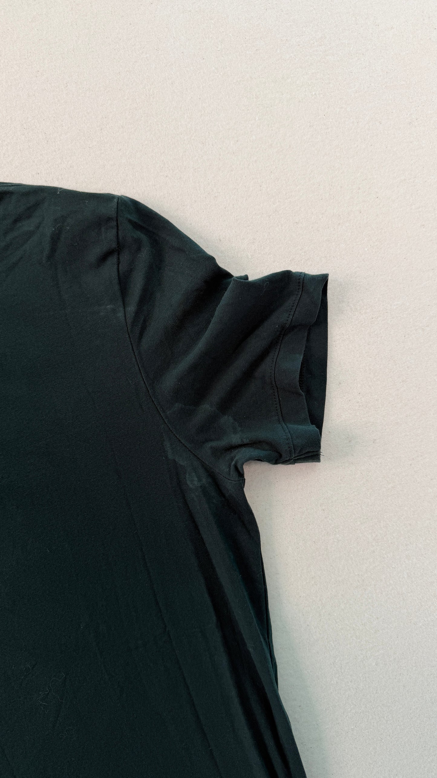 Black t-shirt on a light gray background