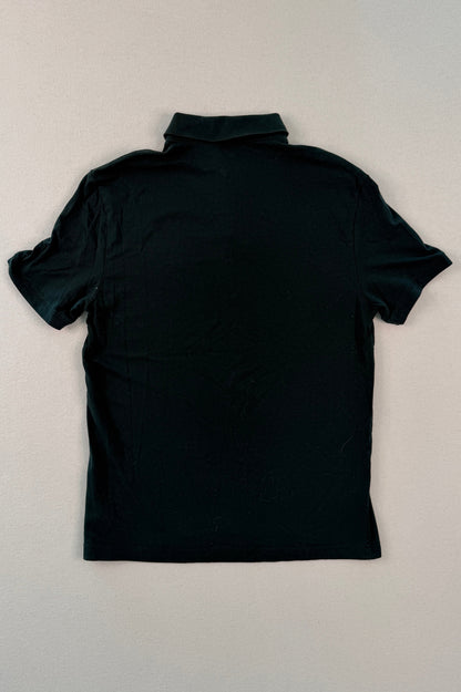 Black turtleneck shirt on a beige surface
