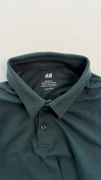 Dark green polo shirt with H&M label on a light gray background