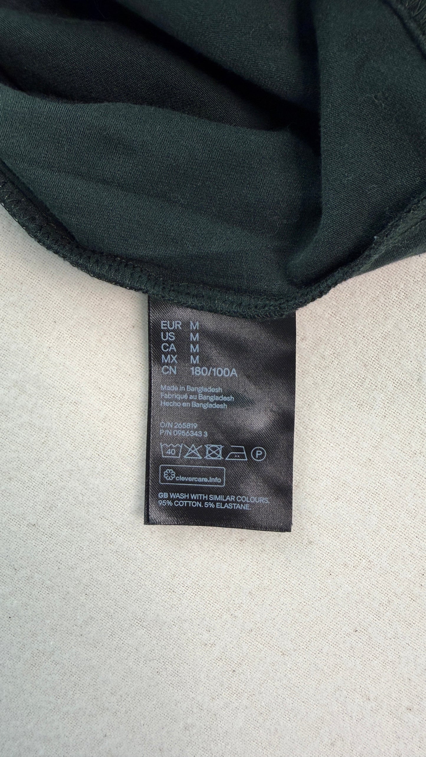 Black bra with a brand label on a light gray background
