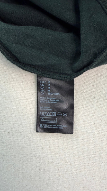 Black bra with a brand label on a light gray background