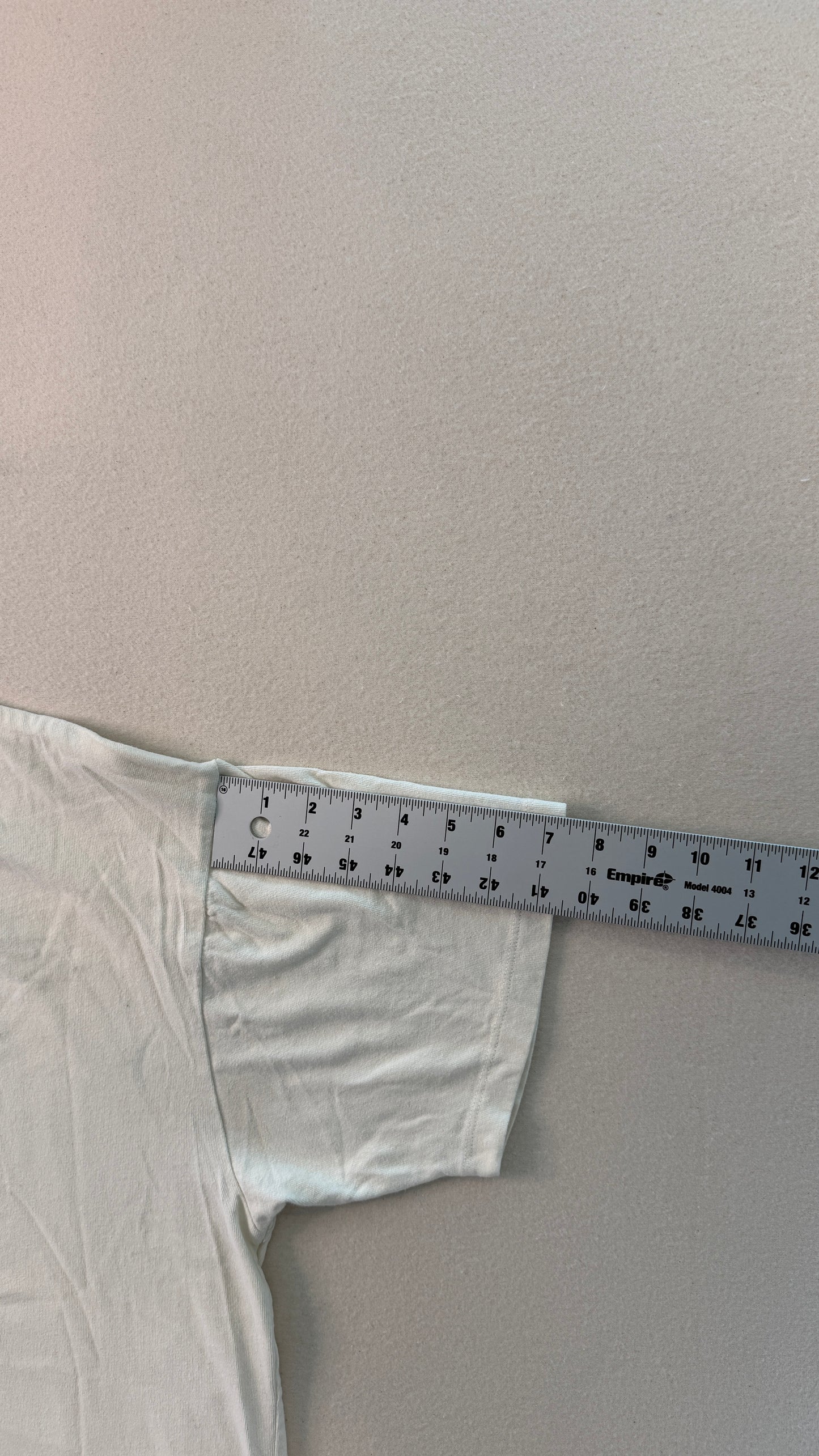 White fabric with a ruler on a plain background