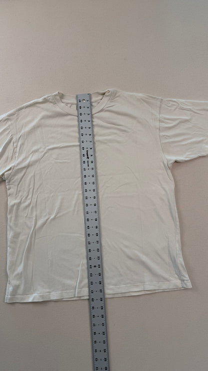 White t-shirt with a ruler for size reference on a plain background