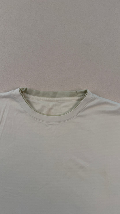 Plain light gray t-shirt on a matching gray background