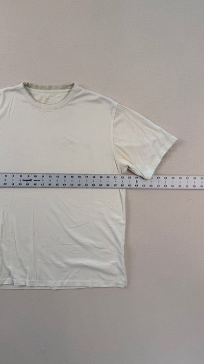 White t-shirt with a ruler for size reference on a gray background