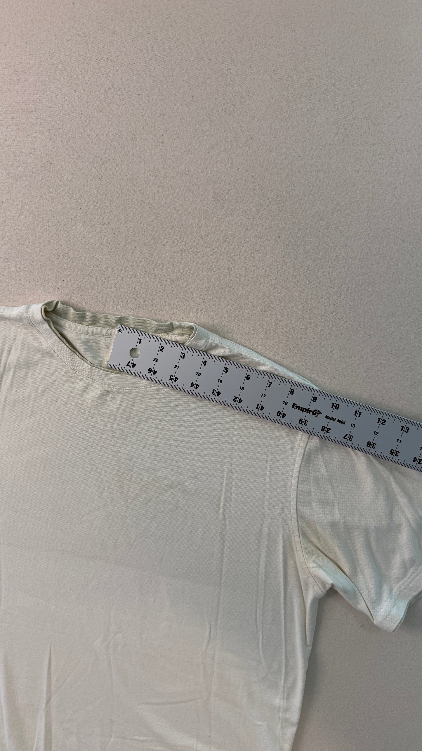 White shirt with a measuring tape on a gray background