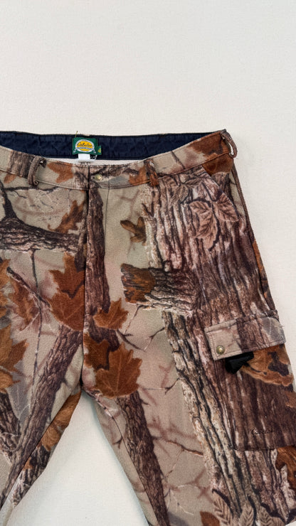 Camouflage pants with a visible brand tag on a white background