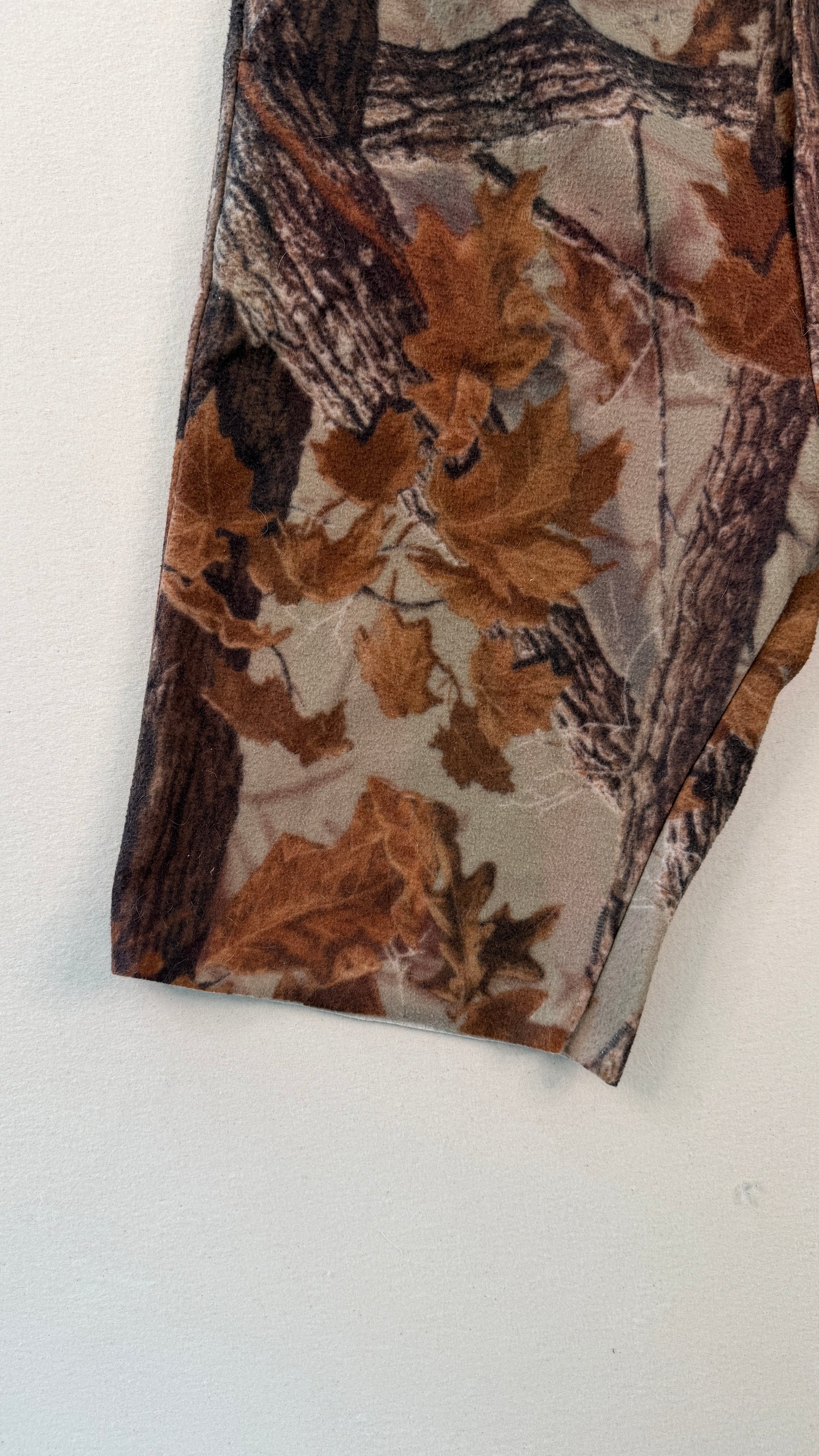 Tie with a nature-themed pattern featuring leaves and branches on a white background