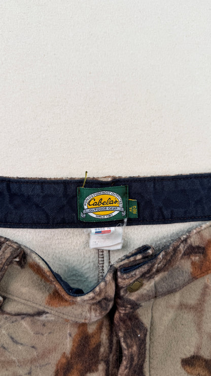 Cabela's branded belt with camouflage pattern on a white background
