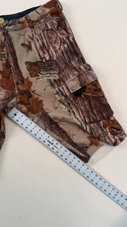 Camo-patterned fabric with a ruler for scale on a white background