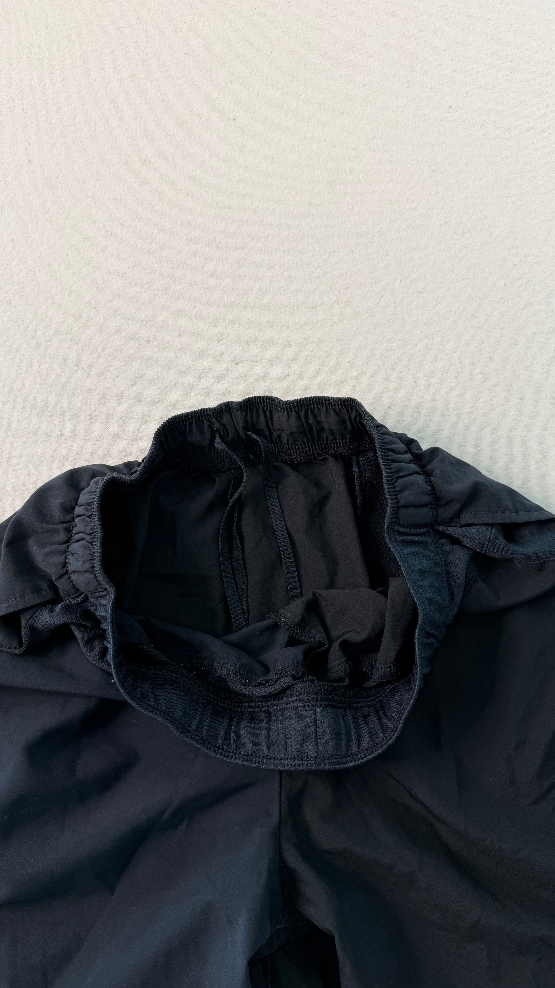 Dark blue jacket with a hood on a light gray background