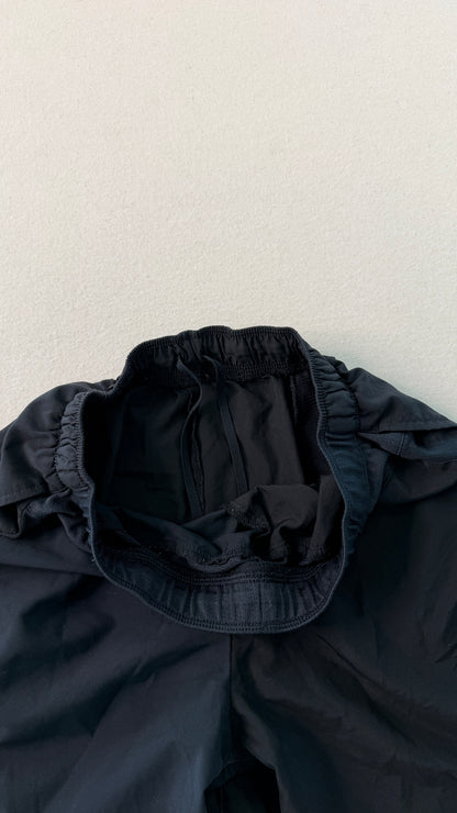 Dark blue jacket with a hood on a light gray background