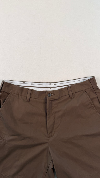 Brown pants with a white waistband on a light gray background