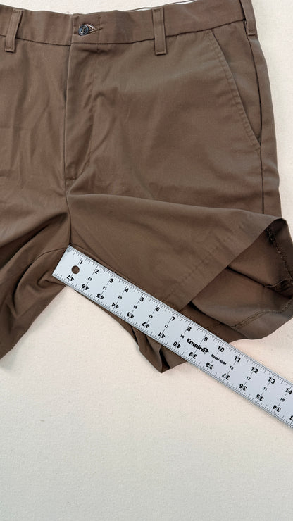 Brown shorts with a ruler for size reference on a light background