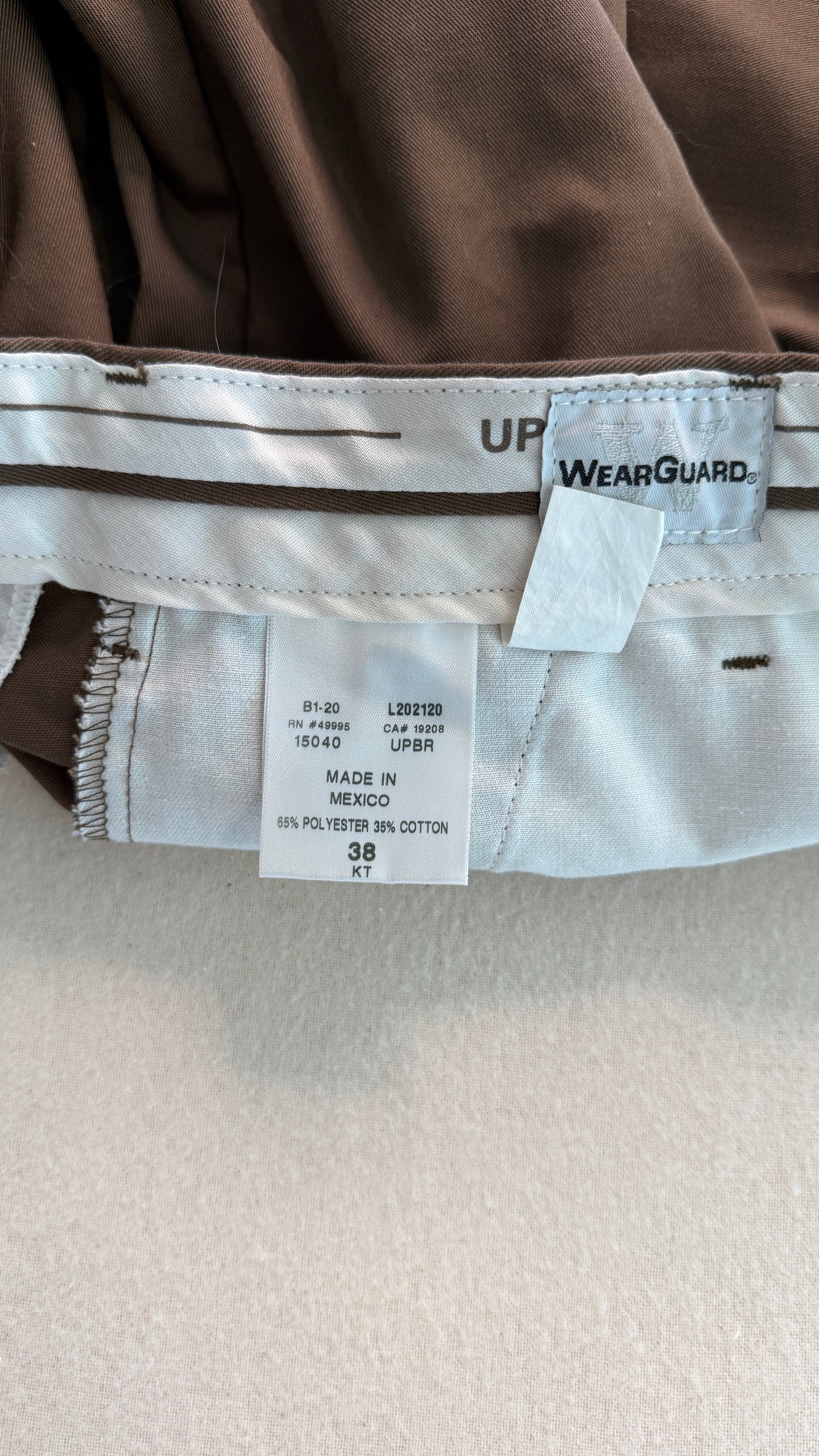 Close-up of a label on a brown garment with 'WearGuard' branding.